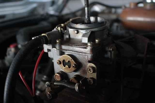 Close-up of a car engine's fuel injector and mechanical components under the hood