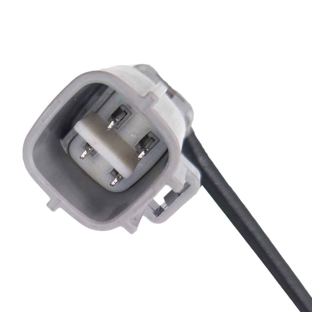 Close-up of a gray automotive electrical connector with four metal pins and attached black wire
