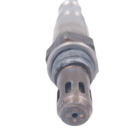 Close-up of an automotive oxygen sensor with metal casing and sensor tip for vehicle emissions control
