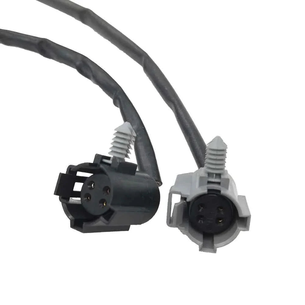 Close-up of black and gray 4-pin automotive electrical connectors with attached wiring harnesses