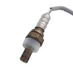 Close-up of an automotive oxygen sensor with metal and plastic components against white background