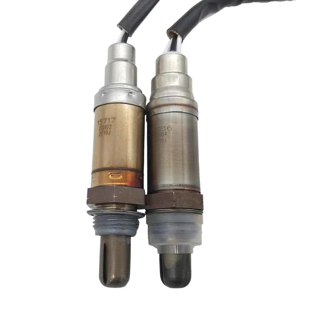 Pair of OEM-quality automotive oxygen sensors with metal and plastic connectors on white background