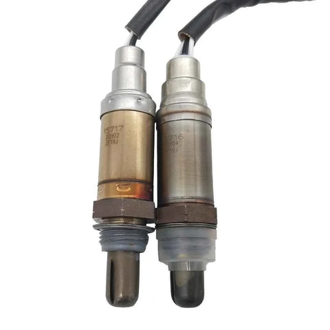Pair of OEM-quality automotive oxygen sensors with metal and plastic connectors on white background