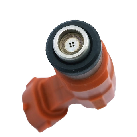 Close-up of an orange automotive fuel injector nozzle with metal tip and black sealing ring