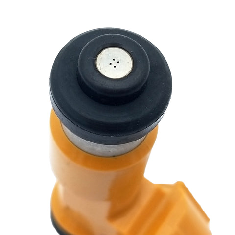 Close-up of an automotive fuel injector nozzle with yellow body and black tip