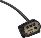 Close-up of a black automotive sensor connector with cable against white background