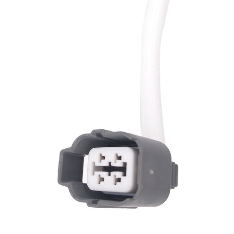 Close-up of gray automotive electrical connector plug with white wiring on white background