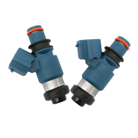 Pair of blue automotive fuel injectors with black and orange seals isolated on white