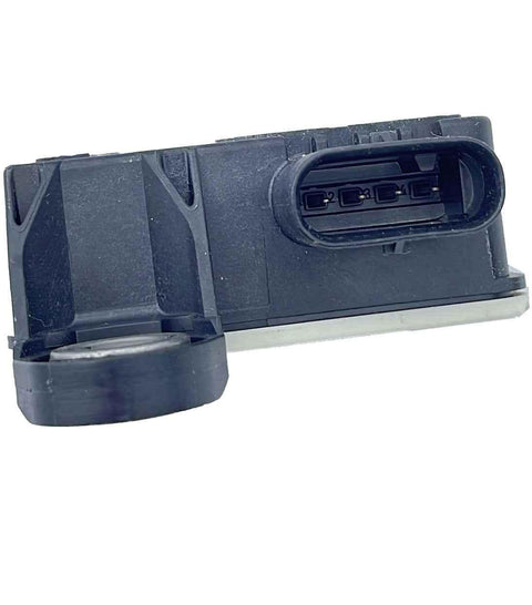Close-up of a black automotive ignition coil with electrical connector, isolated on white