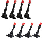 Set of eight black automotive ignition coils with red caps arranged in two rows on white background